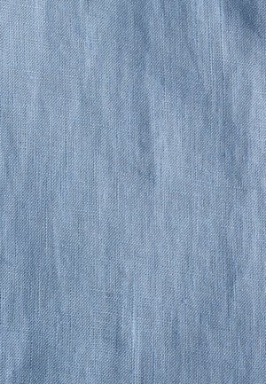 Light blue textured fabric with a woven appearance. The surface features subtle variations in color and pattern, resembling denim.