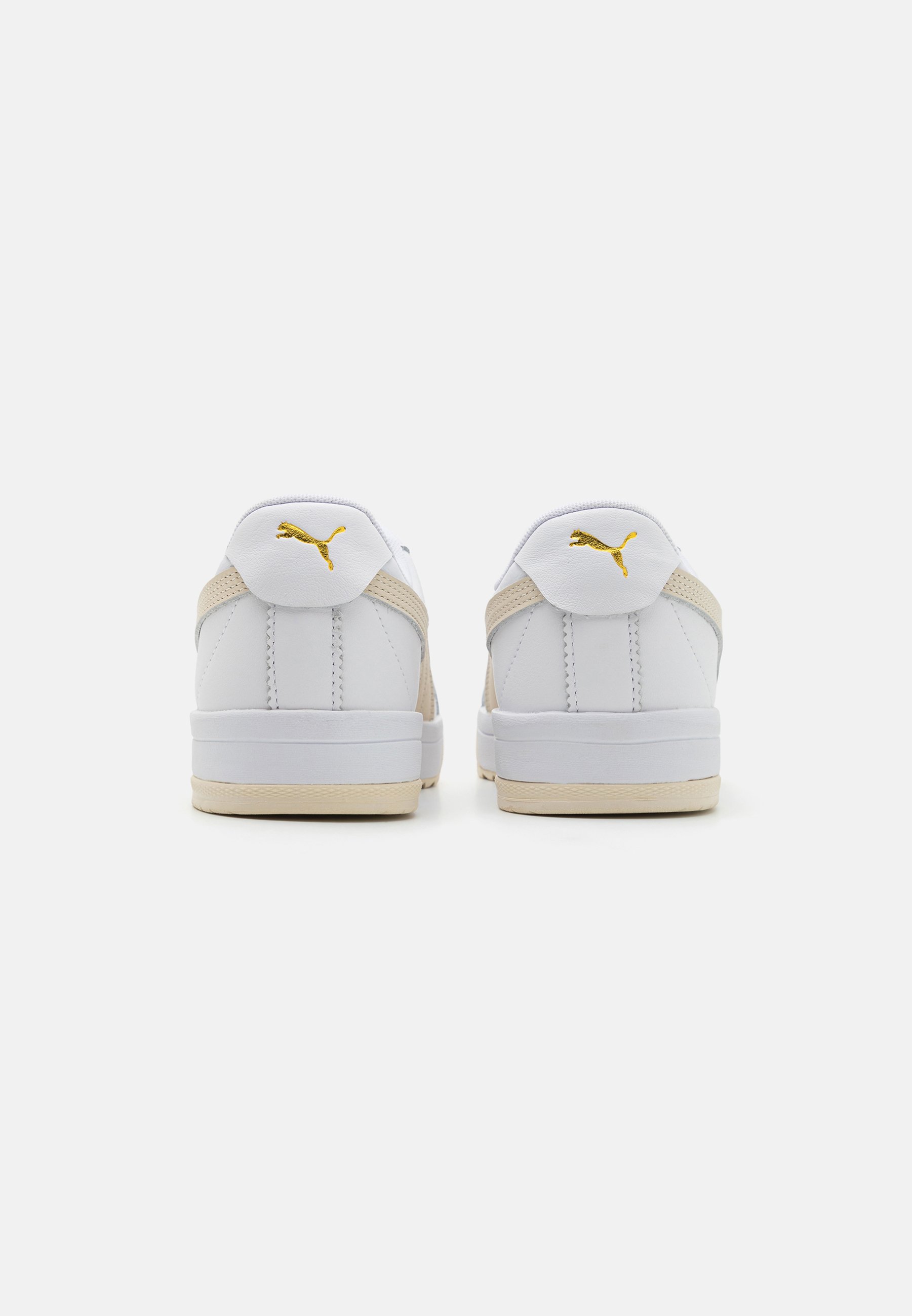 white pumas with gold toe