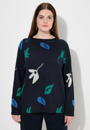 Pull en tricot navy, avec un motif floral aux accents verts et bleus. Encolure ronde, manches longues et coupe décontractée.