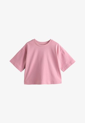 Loose-fitting short-sleeve cropped T-shirt in solid pink with a round neckline on a white background.
