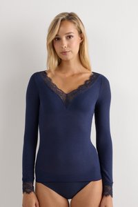 Navy long-sleeve top with a V-neck, featuring lace trim along the neckline and sleeves. Soft, fitted fabric with a smooth texture.