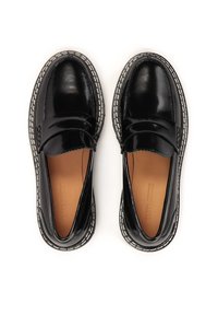 Black patent leather loafers with a rounded toe, featuring dual straps, contrasting white stitching, and a tan interior.