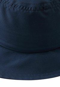 Granatowy kapelusz typu bucket, wykonany z gładkiego materiału. Posiada zaokrągloną koronę i szeroki, przeszyty rondo. Minimalistyczny design bez wzorów i zdobień.