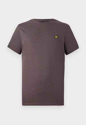 Jednostavna smeđa majica kratkih rukava s malim žutim logom ptice na lijevoj strani grudi, prikazana na svijetloj pozadini.
