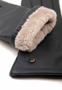 Navy leather gloves with a soft beige fur lining and a metallic logo button. Features include a sleek design and smooth texture.