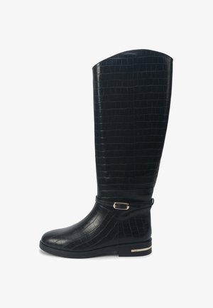 Black knee-high boot with a faux croc-embossed texture, flat sole, gold-tone buckle accent, and smooth finish on the upper section.