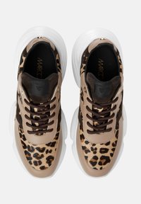 Pair of chunky sneakers with brown leopard print, beige leather accents, dark brown laces, and thick white soles, viewed from above.