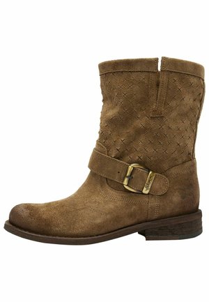 Botín de ante marrón hasta el tobillo con un patrón texturizado, presenta un acento de hebilla lateral y un tacón bajo apilado. Diseño simple y funcional.