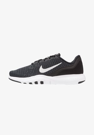 Chaussure de running Nike noire avec semelle blanche et logo swoosh blanc, dessus en mesh respirant et lacets noirs, vue de côté.