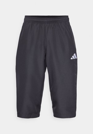 Black sports shorts made of lightweight material, featuring an elastic waistband and Adidas logo in white on the side. Knee-length design.