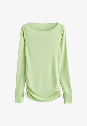 Gaiši zaļa garroku topiņš no gludas auduma. Tam ir plats kakla izgriezums un savilkti sānu elementi pieguļošam izskatam.