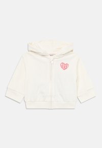 Ivory zip-up hoodie with short sleeves, soft fabric, features a pink heart logo on the left chest, and a drawstring hood.