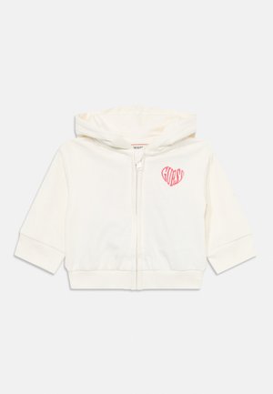 Elfenbenfarget zip-up hettegenser med korte ermer, mykt stoff, har et rosa hjerte-logo på venstre bryst og en hette med snøring.