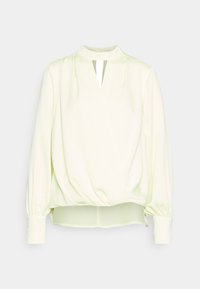 Blusa amarelo claro com gola alta falsa, mangas bufantes longas e uma pequena abertura em forma de gota. Tecido suave e liso com um design franzido na cintura.