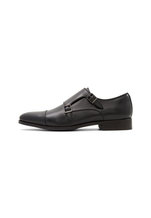 Black leather double monk strap dress shoe with a cap toe and low stacked heel, shown from the outer side on a white background.