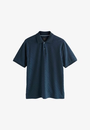 Camisa polo azul marino con un patrón de espiga texturizado, manga corta y cuello con dos botones. Fabricada en tejido transpirable.