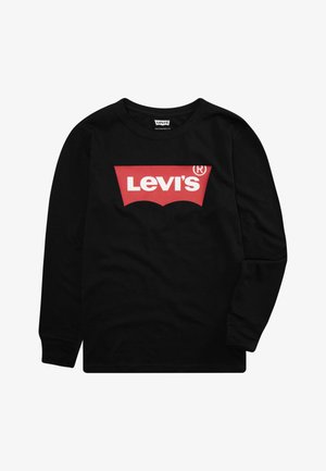 Melna gara piedurkņu T-kreklu, kas izgatavots no kokvilnas, ar sarkano Levi's logo, kas ir izstrādāts baltajā kontūrā uz priekša. Tam ir apaļa kakla izgriezums un ribotas aproces.