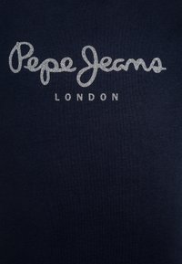 Mörk marinblå T-shirt med slät tyg, prydd med silverglittrande bokstäver som säger "Pepe Jeans London." Enkel, minimalistisk design.