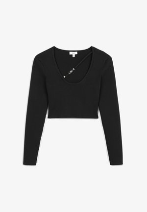 Black ribbed long-sleeve crop top with a scoop neck and cross-back design. Features a subtle "LOVE" detail on the strap.
