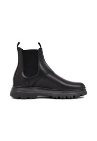 Botas Chelsea de cuero negro con paneles laterales elásticos, suela de goma texturizada y asas para facilitar su puesta. Diseño duradero y versátil.