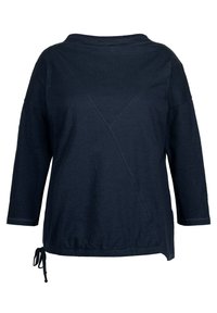 Navy blauwe lange mouwen top met een brede halslijn, asymmetrische naden en een verstelbare koord bij de onderkant. Zachte stofstructuur zichtbaar.