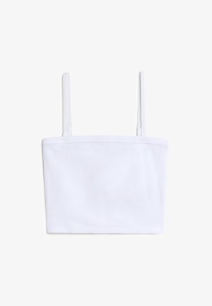 Crop top blanc à côtes avec des fines bretelles réglables et un décolleté droit. La texture du tissu semble douce et légèrement extensible.