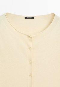 Light beige button-up cardigan with round neckline and four matching buttons, showing Massimo Dutti label inside collar.