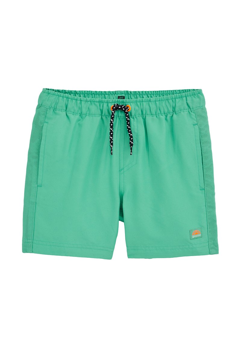 Zaļas peldbikses ar elastīgu vidukļa joslu, melnu un baltu auklu, acs sānjoslām un nelielu saules logotipu apakšējā labajā kājā.