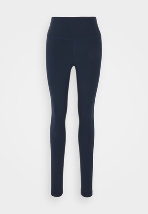 Middenblauwe leggings met een hoge taille, gemaakt van elastische stof. Glad textuur, geen patronen en een getailleerde vorm. Zijden naden zichtbaar.