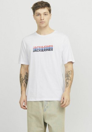 T-shirt en coton blanc présentant un logo "JACK & JONES" multicolore sur la poitrine en rouge, bleu et noir. Coupe décontractée avec des manches courtes.