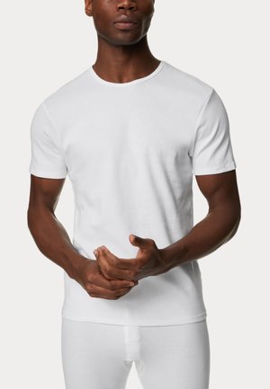 Weißes T-Shirt mit kurzen Ärmeln aus Baumwolle und Rundhalsausschnitt. Glatte Textur, taillierte Passform und ein einfacher, klassischer Schnitt.