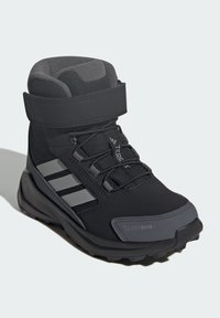 Black hiking boot with a padded collar, sturdy sole, reflective accents, and a secure strap. Features ClimaWarm technology for insulation.