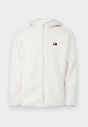 Biely fleecový zipsový mikina s jemnou textúrou, s kapucňou a bočnými vreckami. Malé logo na ľavej hrudi. Hladký zipsový uzáver.