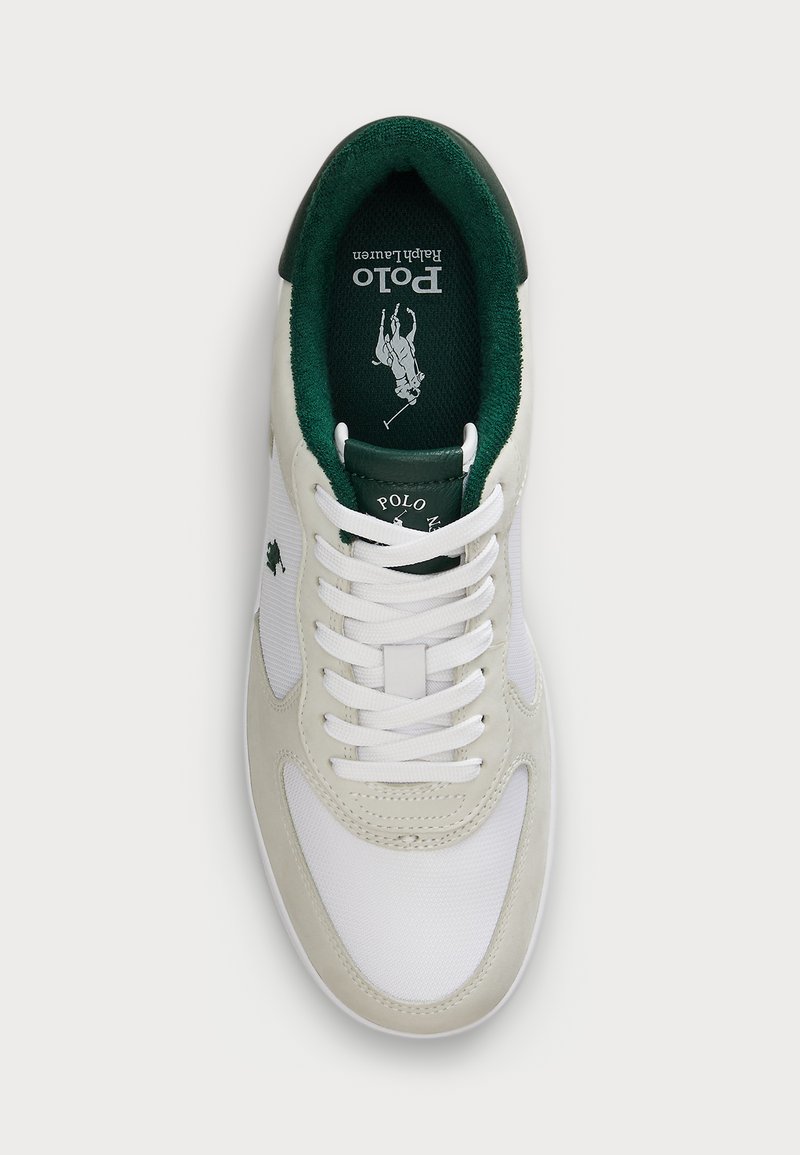 Sneaker bianco con dettagli verdi, materiali in suede e rete, caratterizzato da un logo prominente, allacciatura tradizionale e una soletta testurizzata.