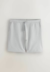 Shorts décontractés gris clair avec ceinture élastique et cordon, avec deux poches latérales, posés à plat sur un fond neutre.