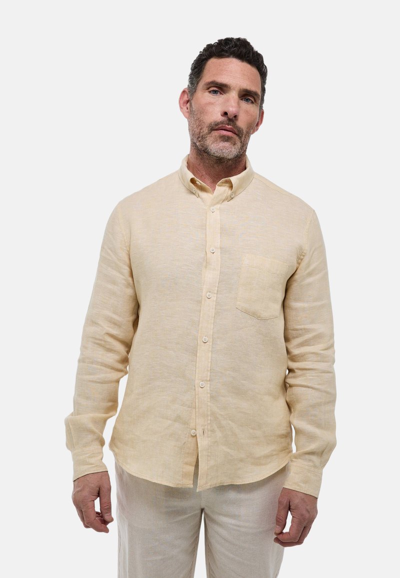 Chemise en lin à manches longues de couleur jaune clair, avec un col à boutons, une poche poitrine unique et une coupe décontractée avec une finition texturée.