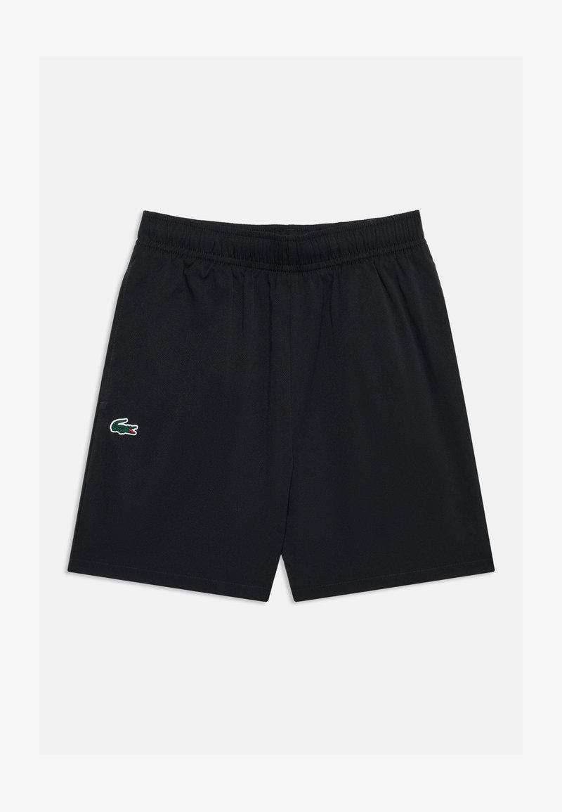 Shorts de sport noirs avec ceinture élastique et petit logo crocodile vert sur la jambe gauche sur fond uni.