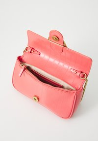 Coral leather handbag with a crocodile texture, gold hardware, magnetic snap closure, and an interior zip pocket. Open, showing inside.