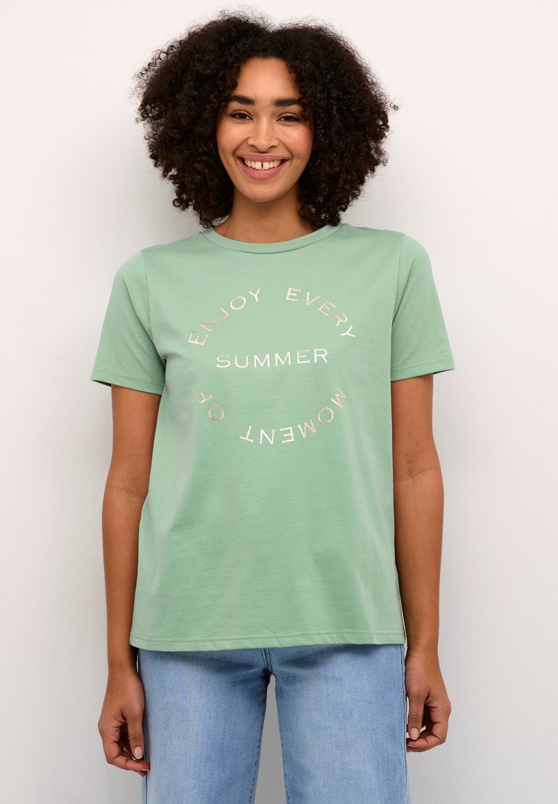 Mintgroene T-shirt van katoen met korte mouwen en ronde halslijn; voorzien van cirkelvormige witte en metallic gouden tekst.