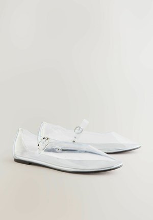 Ballerines en plastique transparent avec des orteils pointus, des accents argentés et une bride à boucle. Texture lisse et design épuré. Ajustement réglable.