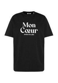 Black cotton t-shirt featuring a white graphic print that reads "Mon Coeur" along with "SENSES.THE LABEL" beneath it. Short sleeves, crew neck.