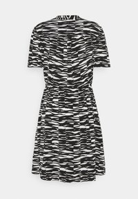 Black and white short-sleeve dress featuring a wavy, striped pattern, elastic waistband, and a flared skirt design.