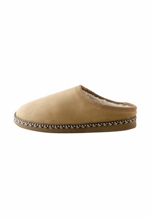 Brown slipper with soft suede upper, cozy faux fur lining, rounded toe, and decorative braided trim along the sole.