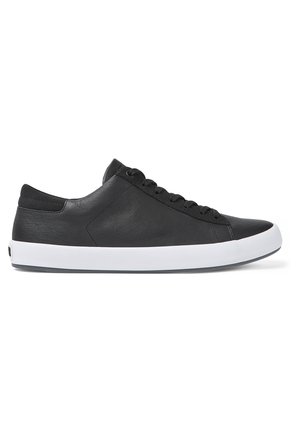 Black leather sneaker with a low-top design, featuring a white rubber sole, six eyelets, and a smooth texture.