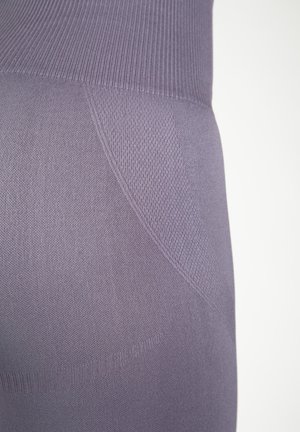 Paarse legging met een gestructureerde afwerking en een gladde tailleband. Kenmerken zijn de benadrukte naden en de strakke pasvorm, ontworpen voor comfort en flexibiliteit.