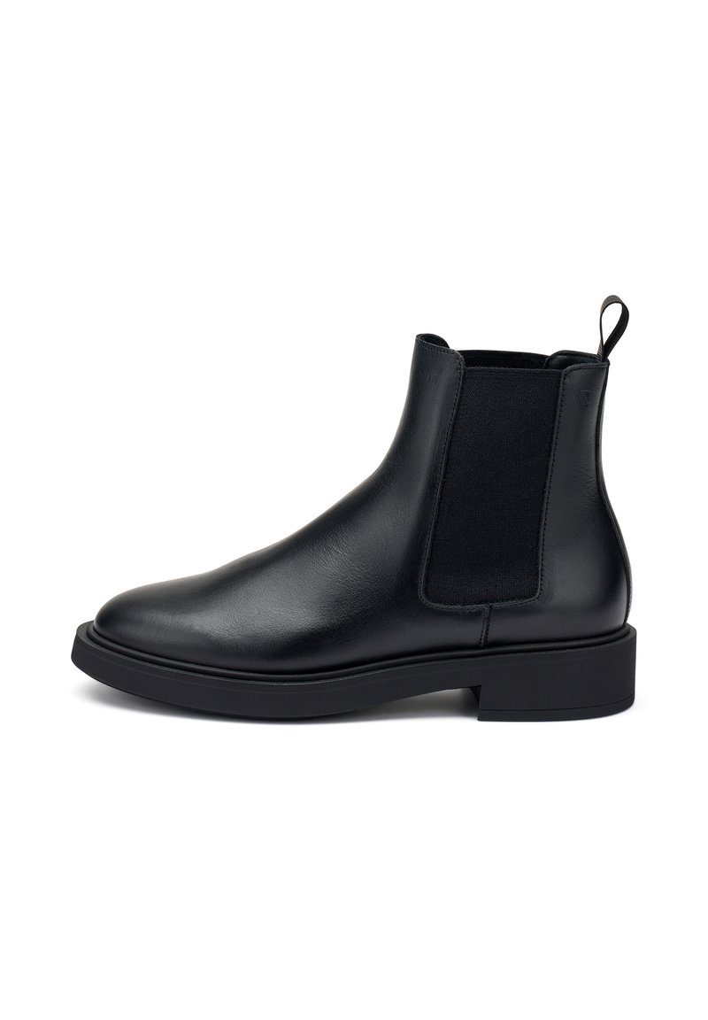 Botas de tobillo de cuero negro con paneles elásticos a los lados, punta redondeada y una pestaña en la parte posterior. Suela de goma gruesa con un diseño minimalista.