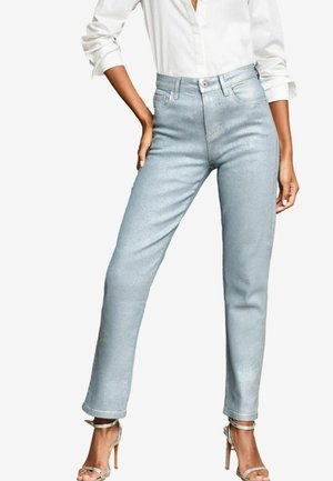 Light blue high-waisted jeans with a slim fit, featuring a button and zipper closure, subtle sheen, and rolled cuffs. Paired with silver heels.