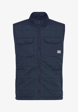 Tumesinine vooderdatud vest, millel on kõrge krae, ees zip-äpping ja kaks rinna taskut, millel on klõpsnupud. Vastupidav kangas ja sile tekstuur.