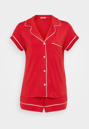 Red pajama set featuring a short-sleeve top with a notched collar, white piping, button closure, and matching shorts. Soft fabric, casual design.