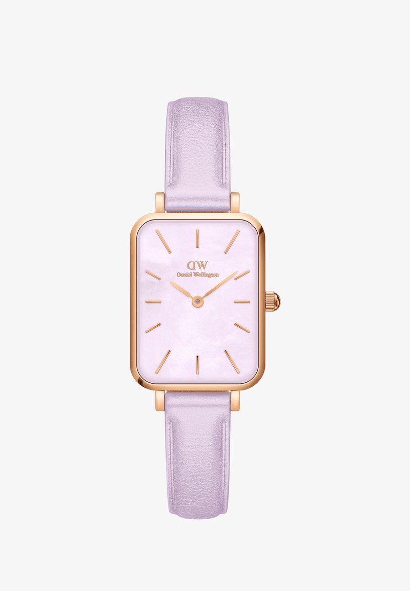 Neljakandiline kell roosakullast metallkorpuses ja lillapunasest nahkrihmast. Omab heledat lillapärast kelladiialit koos kuldsete tundide markerite ja kätega.